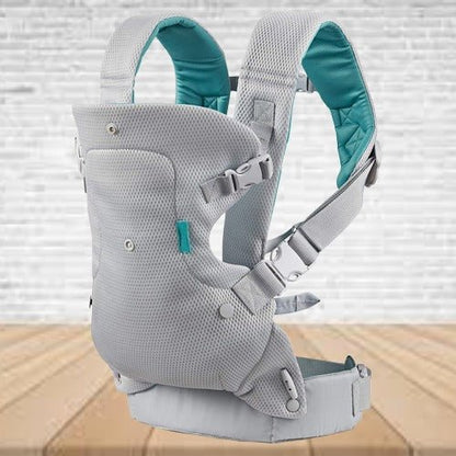 Porte bebe gris clair exposé sur une table dans le jardin, pratique et confortable pour bébé et parent