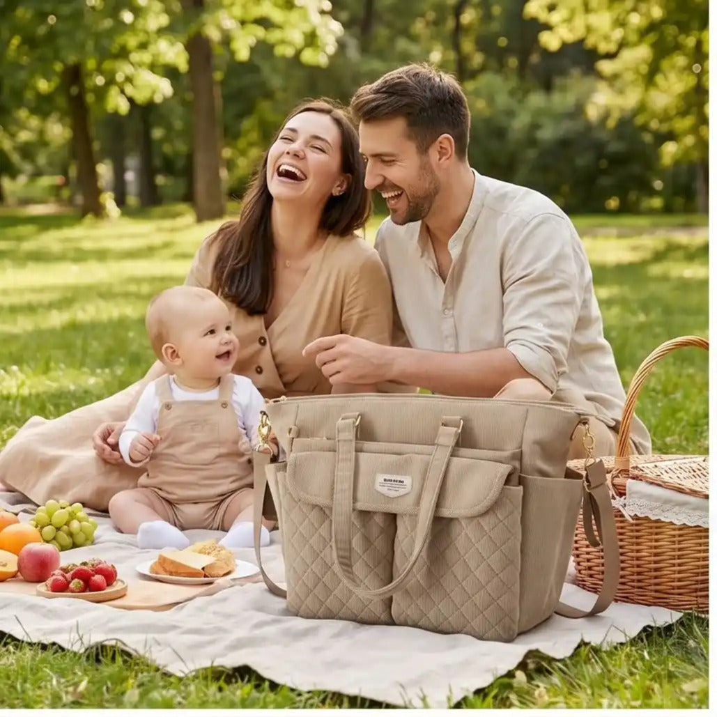 Sac à langer luxe utilisé lors d’un pique-nique en famille avec bébé, pratique pour transporter couches, biberons et accessoires essentiels